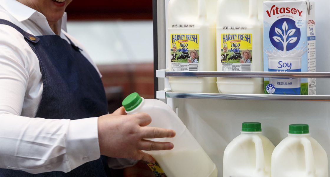 A BrewHub Valet checking milk stocks - Valet services Perth