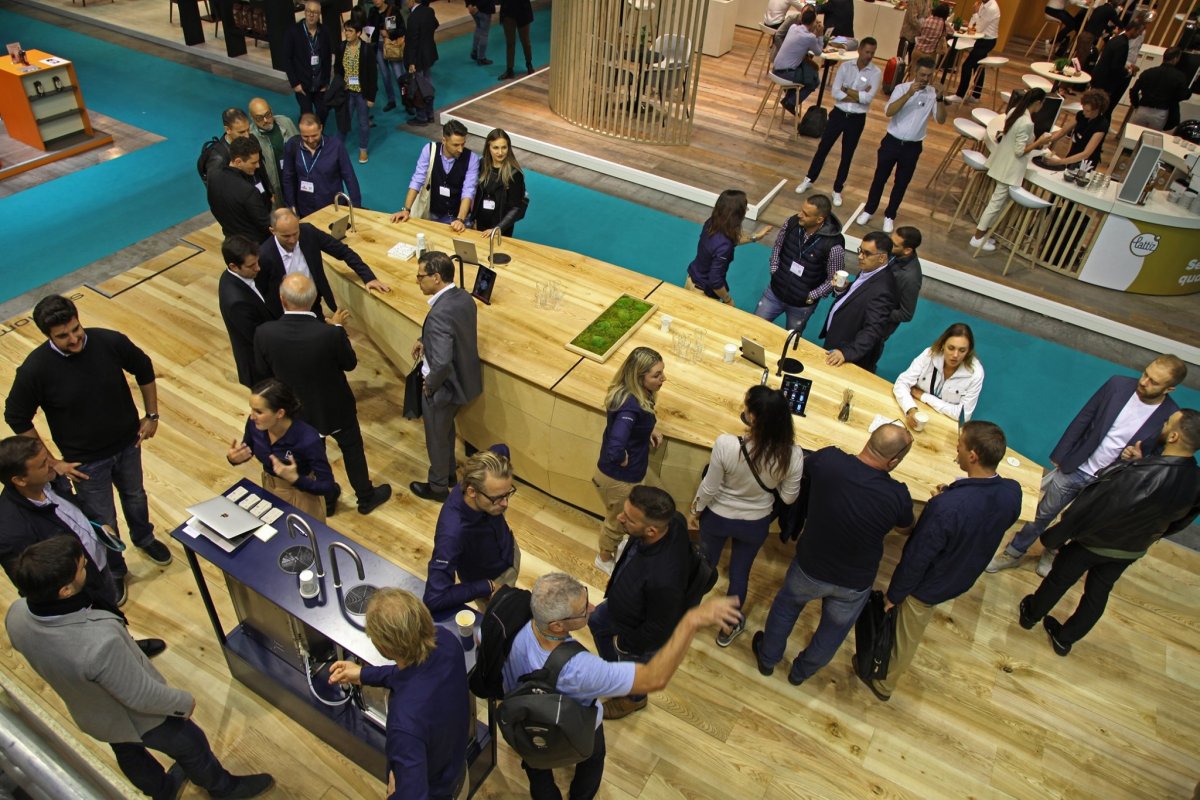 A top view of Scanomat's stand at Host 2019 with people talking around TopBrewers