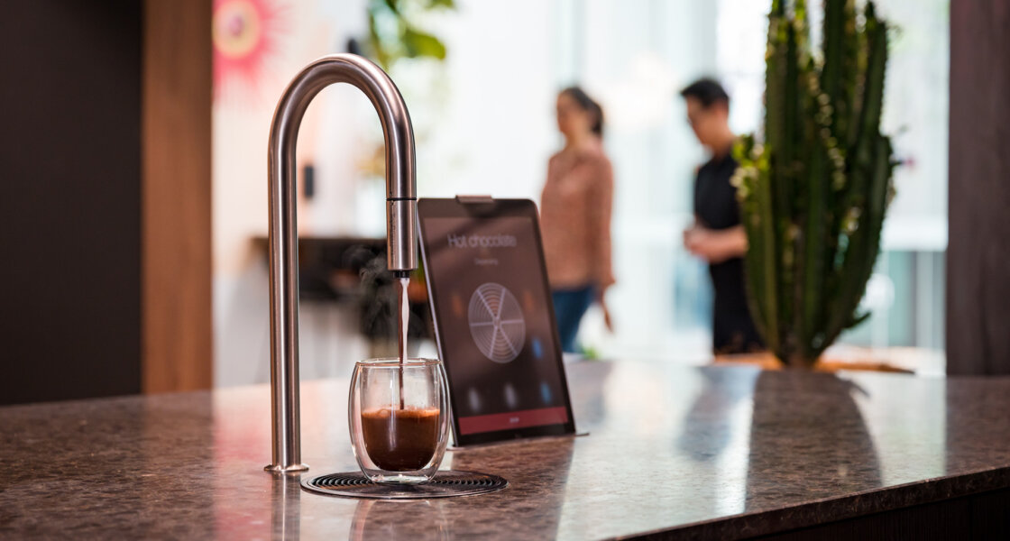 BewHub TopBrewer coffee machine with tempered glass mug of coffee and iPad.