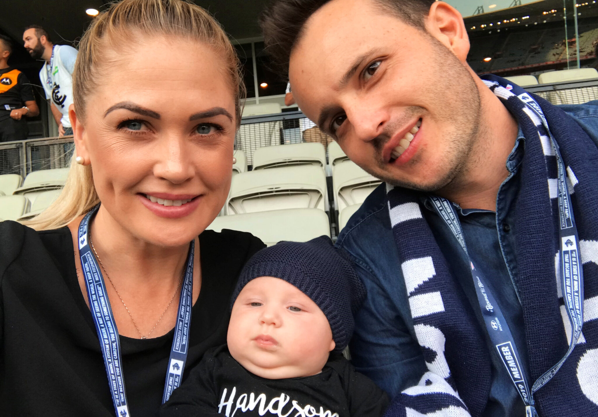Mark, his wife, and 6-month-old son watching his beloved Carlton Football Club at the Melbourne Cricket Ground